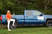 Volunteer with the hole-in-one truck